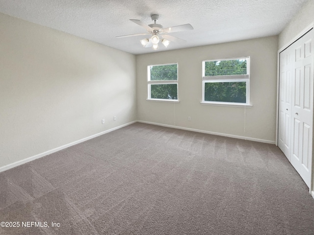 1825 Lago Del Sur Dr, Middleburg, FL 32068 - unfurnished bedroom with a textured ceiling, a closet, baseboards, and carpet