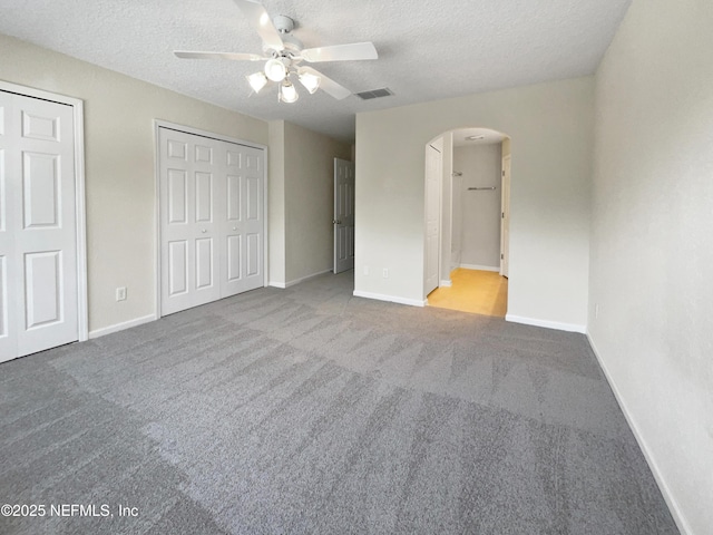 1825 Lago Del Sur Dr, Middleburg, FL 32068 - unfurnished bedroom featuring visible vents, baseboards, arched walkways, two closets, and carpet flooring