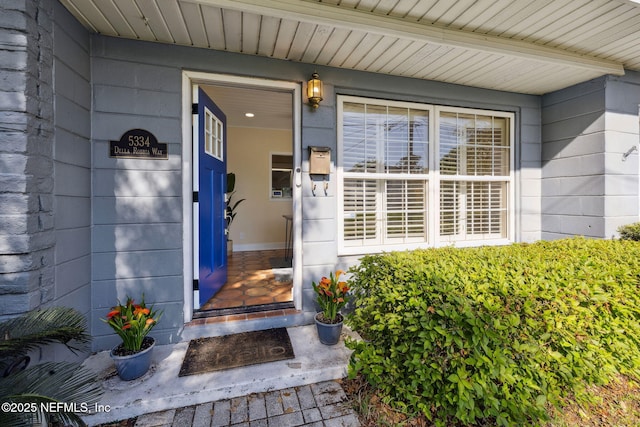 entrance to property featuring concrete block siding