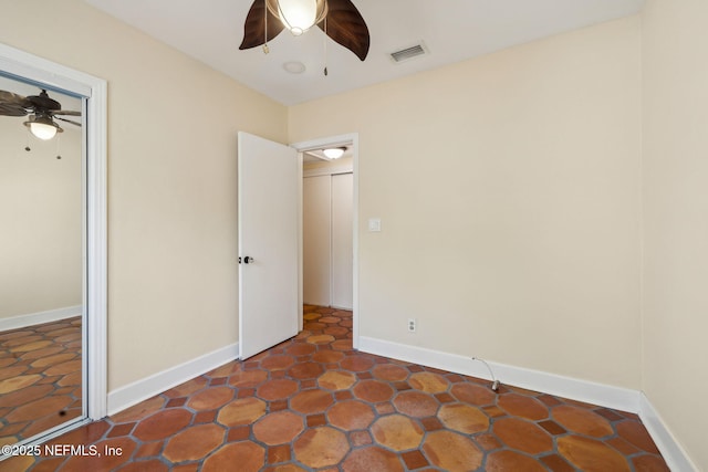 unfurnished bedroom with baseboards, ceiling fan, and visible vents