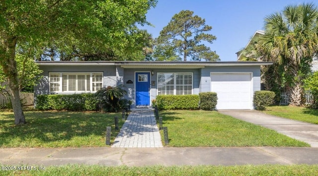 ranch-style home with an attached garage, driveway, and a front yard