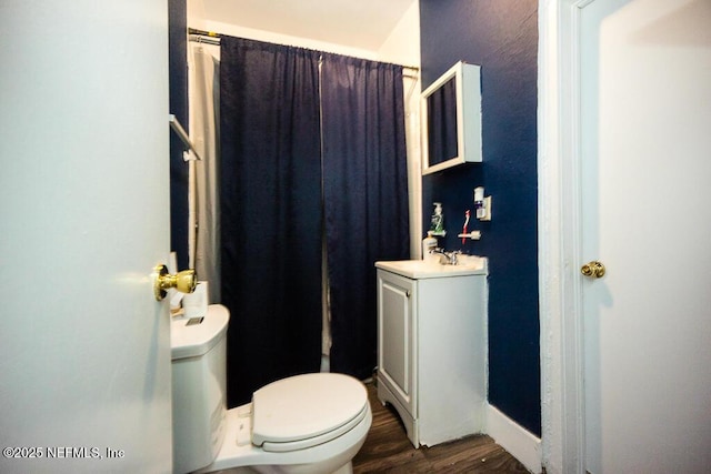 831 Ashford St, Jacksonville, FL 32208 - full bathroom with toilet, wood finished floors, and vanity