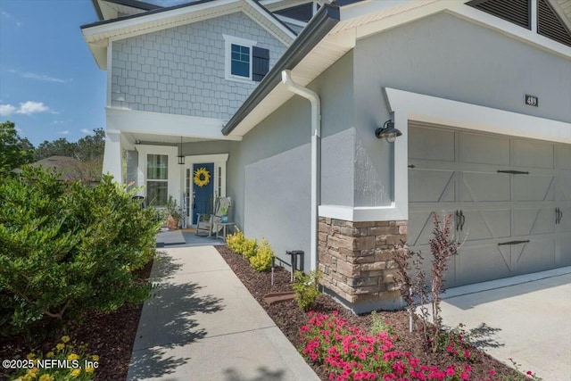 489 Citrus Ridge Dr, Ponte Vedra, FL 32081 - entrance to property with an attached garage, stucco siding, and stone siding