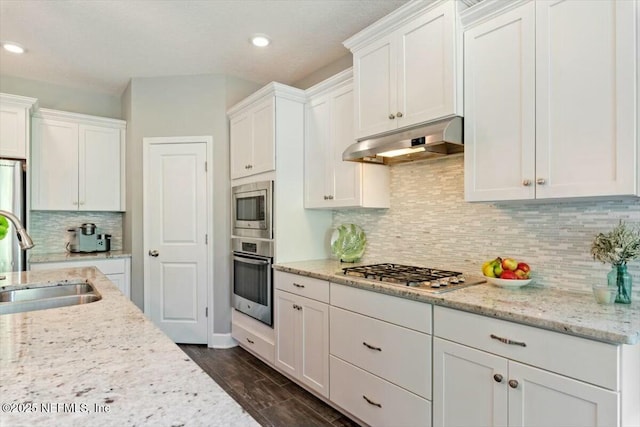 489 Citrus Ridge Dr, Ponte Vedra, FL 32081 - kitchen with stainless steel appliances, under cabinet range hood, white cabinets, and a sink