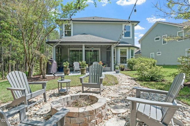 489 Citrus Ridge Dr, Ponte Vedra, FL 32081 - back of house with a shingled roof, a fire pit, a sunroom, a patio area, and stucco siding