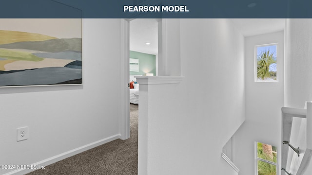 corridor with carpet flooring and baseboards