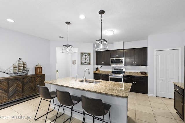 169 S Field Crest Dr, Saint Augustine, FL 32092 - kitchen featuring light stone countertops, appliances with stainless steel finishes, a sink, light tile patterned floors, and visible vents