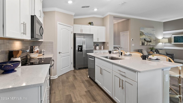 173 Greenwood Dr, Palm Coast, FL 32137 - kitchen with stainless steel appliances, visible vents, a sink, and crown molding