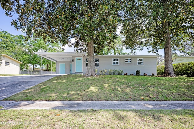 310 Capella Rd, Orange Park, FL 32073 - ranch-style house featuring a front yard, a carport, driveway, and fence