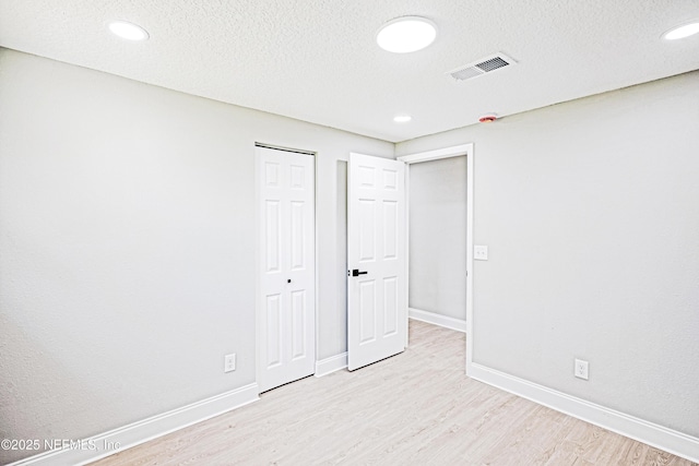 310 Capella Rd, Orange Park, FL 32073 - unfurnished bedroom featuring baseboards, recessed lighting, a textured ceiling, visible vents, and light wood finished floors