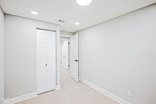 310 Capella Rd, Orange Park, FL 32073 - interior space with light wood-style flooring, a textured ceiling, a closet, visible vents, and baseboards