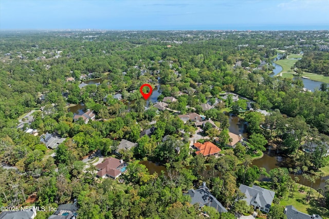 bird's eye view featuring a water view, a residential view, and a wooded view