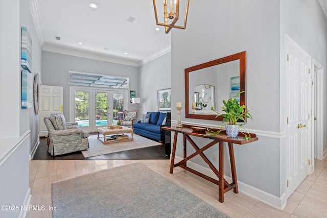 interior space featuring french doors, baseboards, a towering ceiling, recessed lighting, and a chandelier