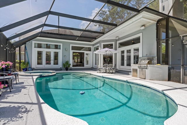 view of swimming pool featuring exterior kitchen, grilling area, french doors, and a patio