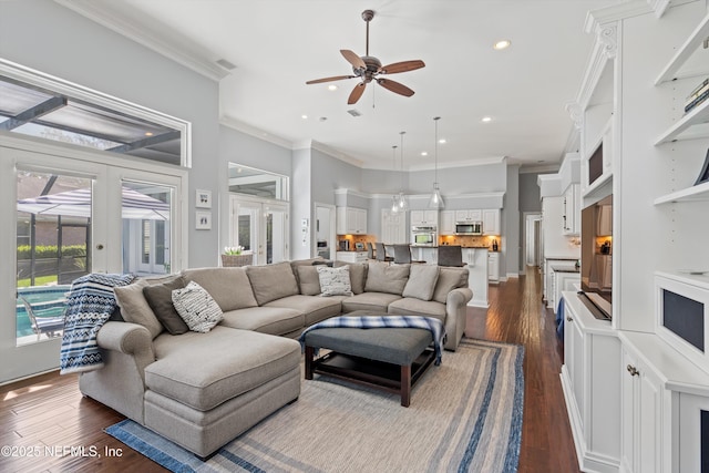 living area featuring a ceiling fan, crown molding, a towering ceiling, dark wood-style floors, and recessed lighting