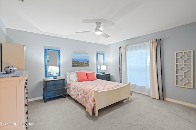 bedroom with baseboards, a ceiling fan, and light colored carpet