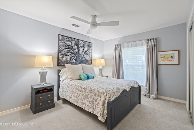 bedroom featuring baseboards, a ceiling fan, visible vents, and light colored carpet