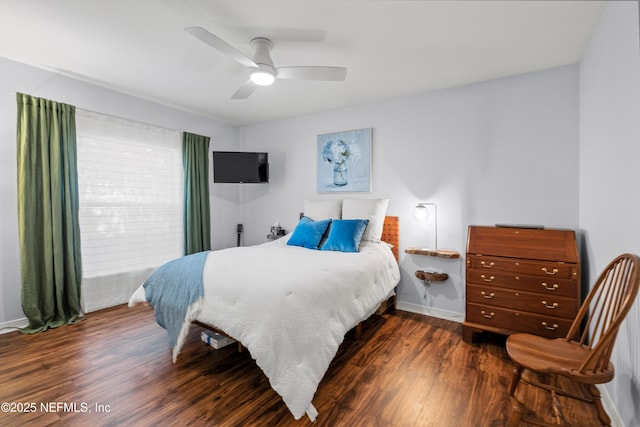 bedroom with ceiling fan, baseboards, and wood finished floors