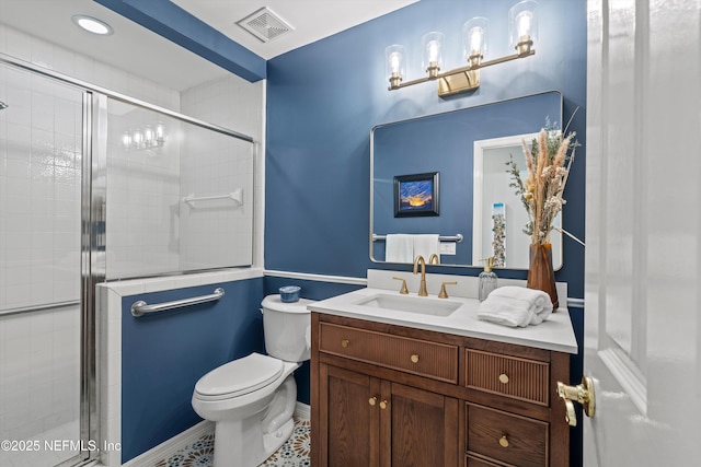 bathroom featuring toilet, a stall shower, baseboards, visible vents, and vanity