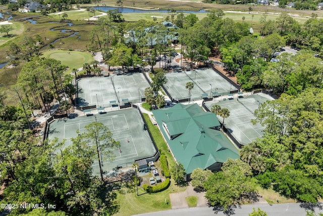 drone / aerial view with a water view and golf course view