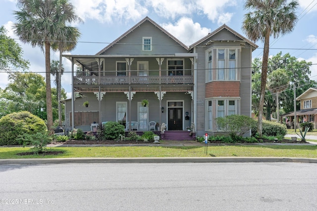 627 Emmett St, Palatka, FL 32177 - view of front of property featuring a porch, a balcony, and a front lawn