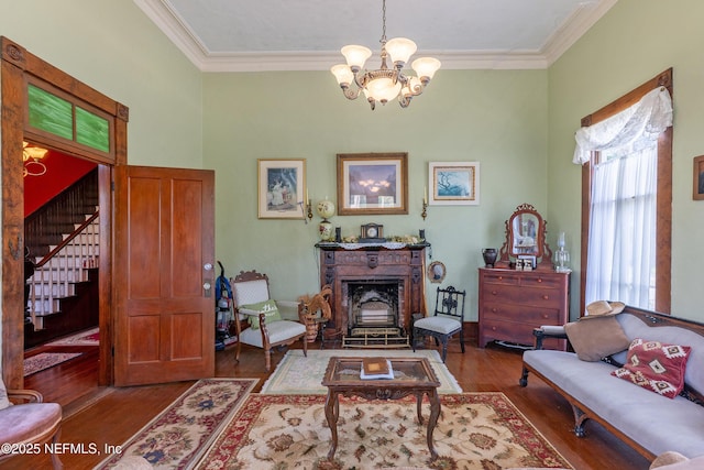 627 Emmett St, Palatka, FL 32177 - living area with wood finished floors, a notable chandelier, ornamental molding, and stairway