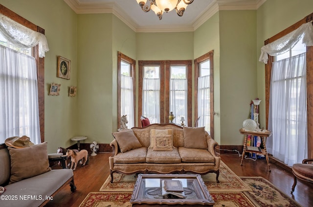 627 Emmett St, Palatka, FL 32177 - living room with ornamental molding, a notable chandelier, wood finished floors, and a healthy amount of sunlight