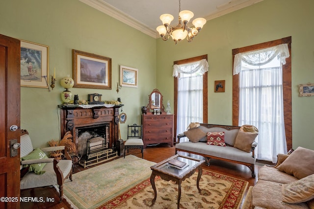 627 Emmett St, Palatka, FL 32177 - living area featuring crown molding, wood finished floors, a fireplace, and a notable chandelier