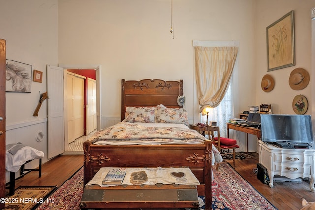 627 Emmett St, Palatka, FL 32177 - bedroom featuring wood-type flooring and a wainscoted wall