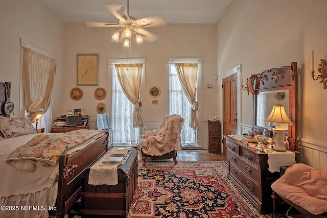 627 Emmett St, Palatka, FL 32177 - bedroom featuring a decorative wall, a ceiling fan, wainscoting, and wood finished floors