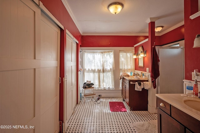 627 Emmett St, Palatka, FL 32177 - bathroom featuring an enclosed shower, crown molding, two vanities, and a sink