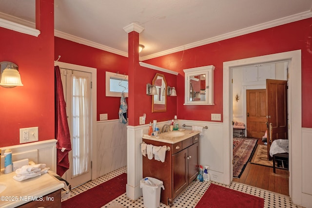 627 Emmett St, Palatka, FL 32177 - bathroom with ornamental molding, ensuite bathroom, wainscoting, and vanity