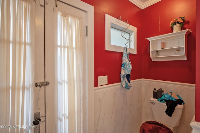 627 Emmett St, Palatka, FL 32177 - bathroom with toilet and wainscoting