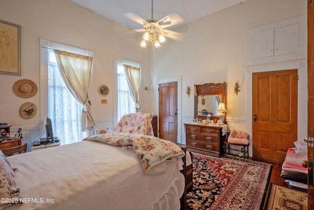 627 Emmett St, Palatka, FL 32177 - bedroom with wood finished floors and a wainscoted wall