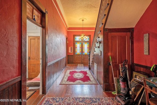 627 Emmett St, Palatka, FL 32177 - foyer entrance featuring a chandelier, hardwood / wood-style floors, wainscoting, and a textured wall