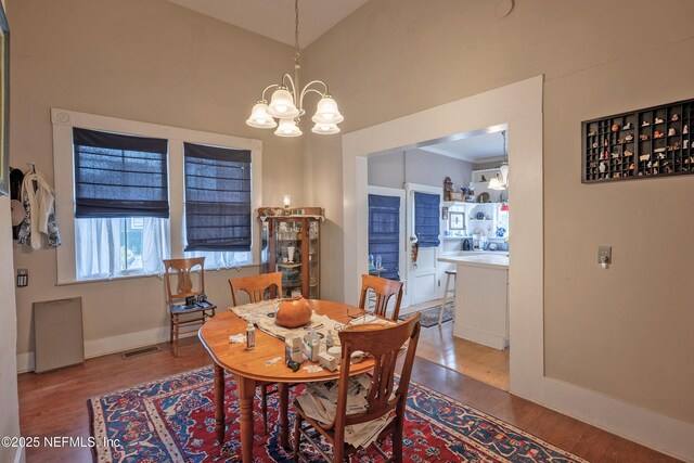627 Emmett St, Palatka, FL 32177 - dining room featuring a chandelier, wood finished floors, baseboards, and visible vents
