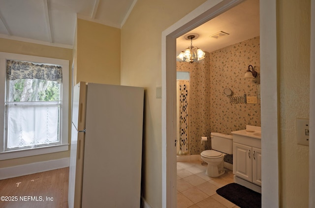 627 Emmett St, Palatka, FL 32177 - bathroom with toilet, visible vents, baseboards, and vanity