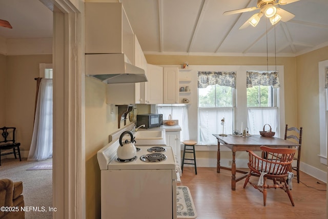 627 Emmett St, Palatka, FL 32177 - kitchen with custom exhaust hood, black microwave, open shelves, white cabinets, and white range with electric stovetop