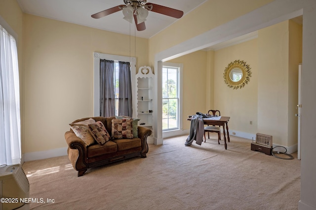 627 Emmett St, Palatka, FL 32177 - carpeted living room featuring baseboards and a ceiling fan