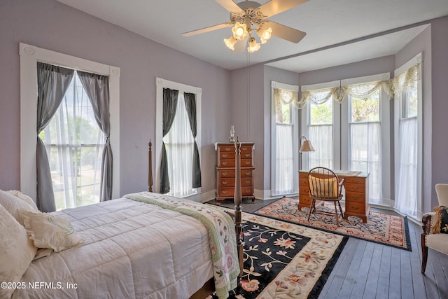 627 Emmett St, Palatka, FL 32177 - bedroom featuring hardwood / wood-style flooring, multiple windows, baseboards, and a ceiling fan