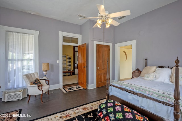 627 Emmett St, Palatka, FL 32177 - bedroom with visible vents, baseboards, ceiling fan, wood finished floors, and a wall unit AC