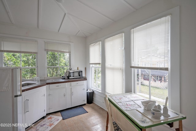627 Emmett St, Palatka, FL 32177 - kitchen featuring dark countertops, stainless steel microwave, and white cabinetry
