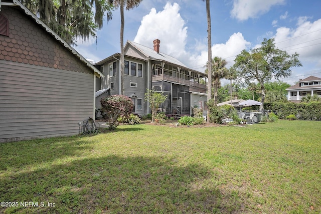 627 Emmett St, Palatka, FL 32177 - back of house with a sunroom and a lawn