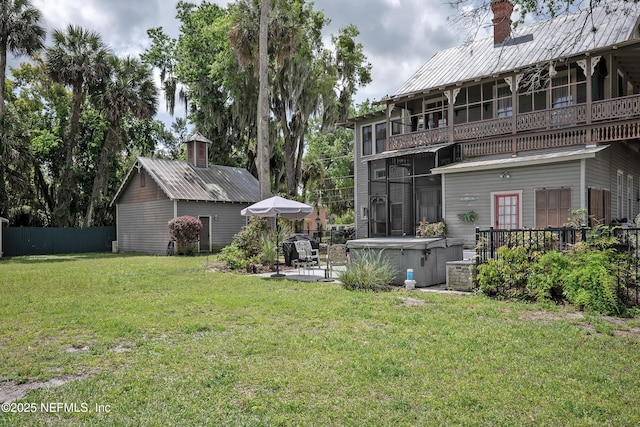 627 Emmett St, Palatka, FL 32177 - rear view of house with a patio area, a lawn, a chimney, fence, and a balcony