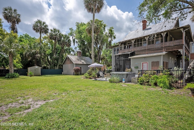 627 Emmett St, Palatka, FL 32177 - view of yard with fence, an outdoor structure, a patio, a storage unit, and a balcony