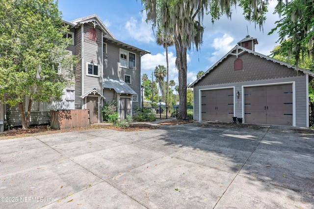 627 Emmett St, Palatka, FL 32177 - exterior space with a chimney, a detached garage, fence, and an outbuilding