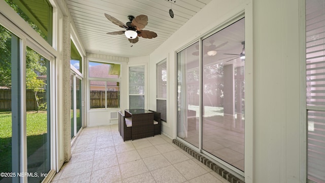 sunroom / solarium featuring ceiling fan