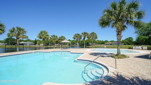 pool with fence and a patio