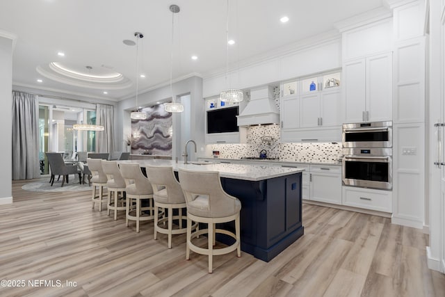 8 Island Estates Pkwy, Palm Coast, FL 32137 - kitchen with crown molding, a breakfast bar, custom exhaust hood, stainless steel appliances, and decorative backsplash