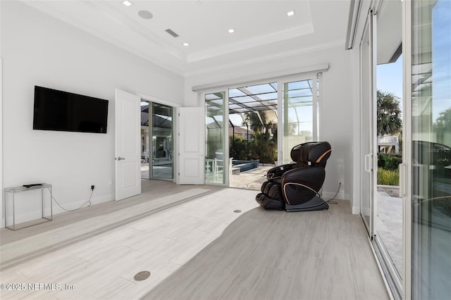 8 Island Estates Pkwy, Palm Coast, FL 32137 - living area with crown molding, visible vents, a tray ceiling, and light wood-style floors